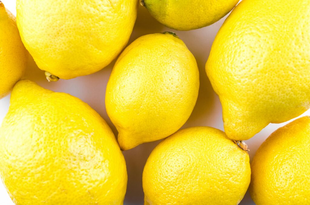 Vibrant close-up of fresh lemons showcasing their bright yellow color and texture.